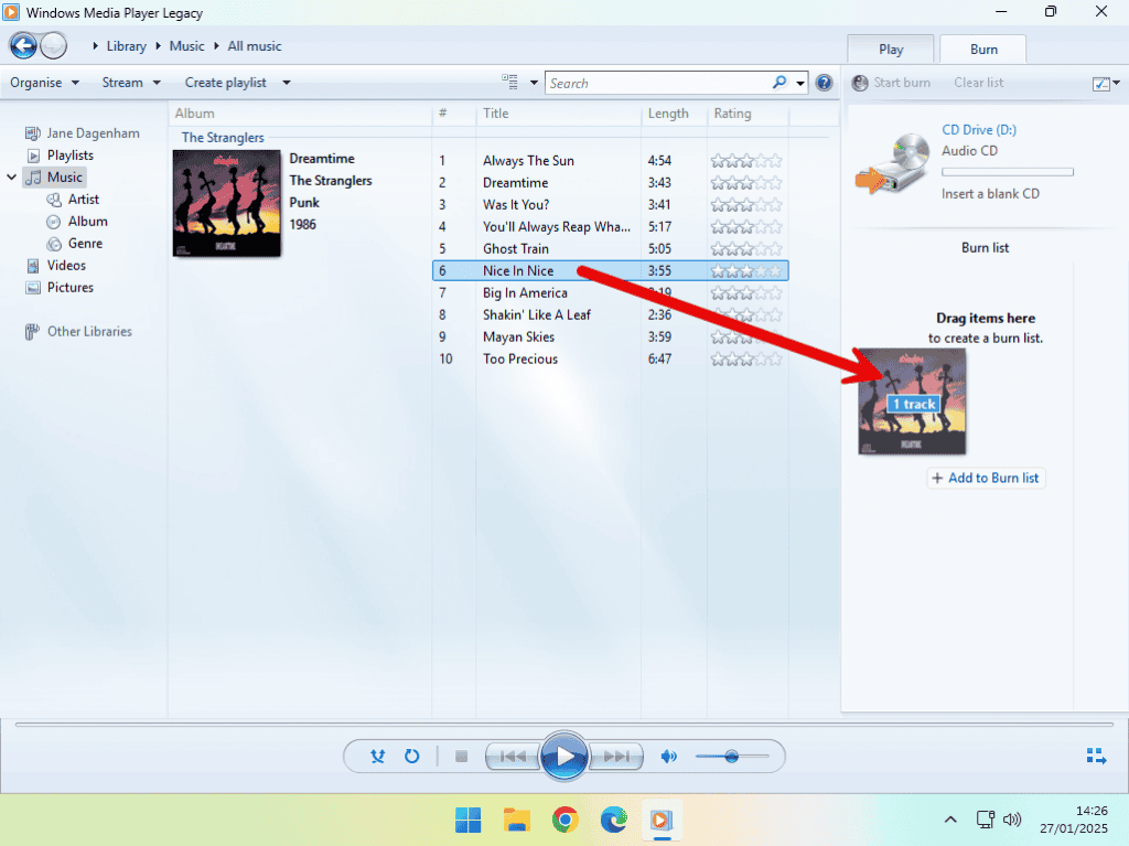 A music file is being dragged and dropped onto the Media player Burn List to be burned to a CD.